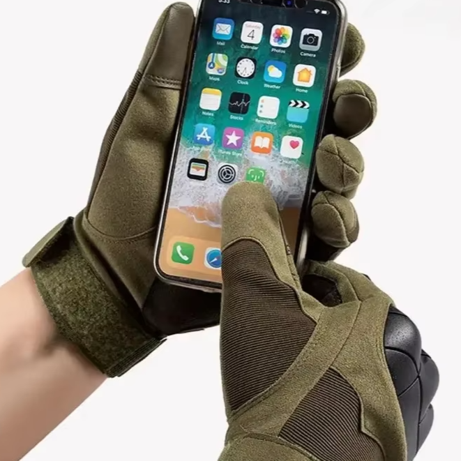 A person wearing green Touch Screen Medium Knuckle Gloves is holding a smartphone