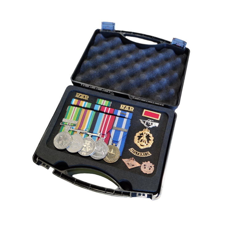 Set of medals and ribbons in a black case on a white background