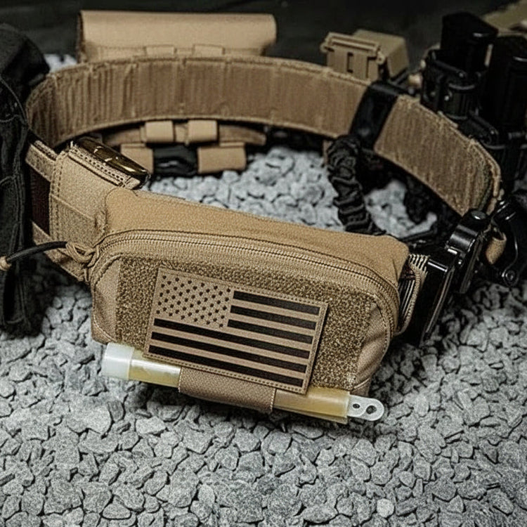 Tactical belt with pouches and American flag design on a rocky surface