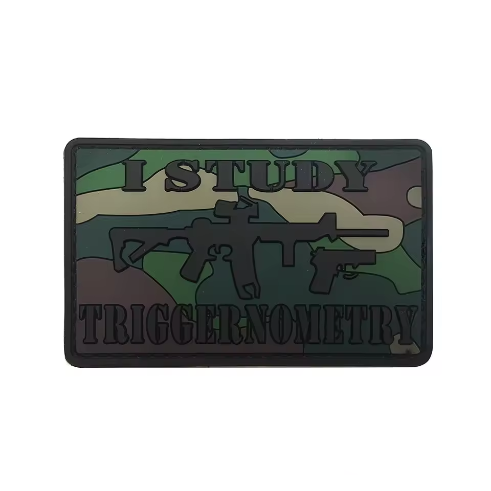PVC patch with text 'I STUDY TRIGGERNOOMETRY' and gun graphics on a camouflage background.