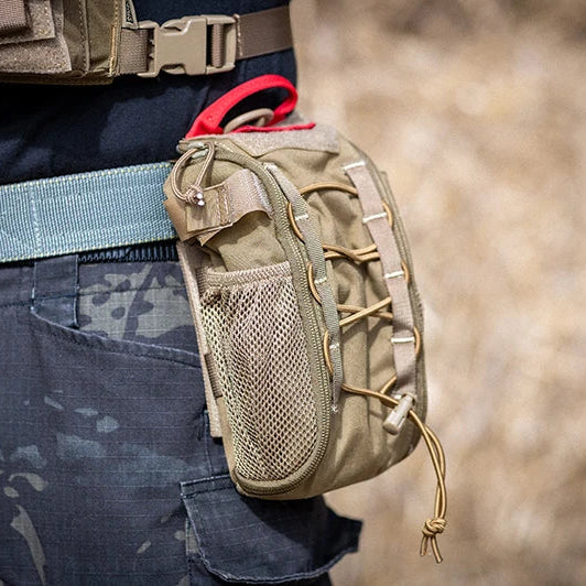 Tan tactical pouch attached to a person's waist with camouflage pants and belt.