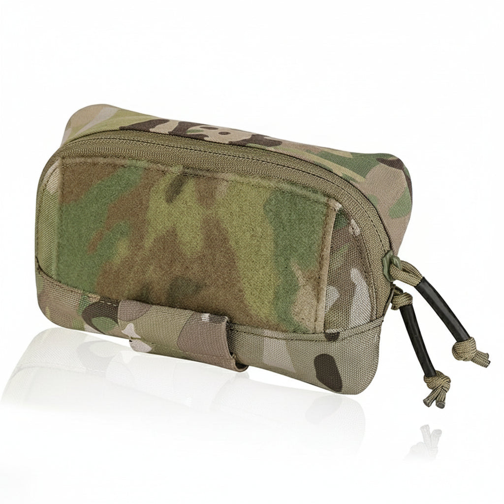 A multicam camouflage-patterned utility pouch with a MOLLE panel, zipper closure, and straps, designed for outdoor activities.