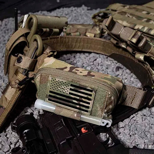 Tactical belt with pouches and American flag patch on a textured surface