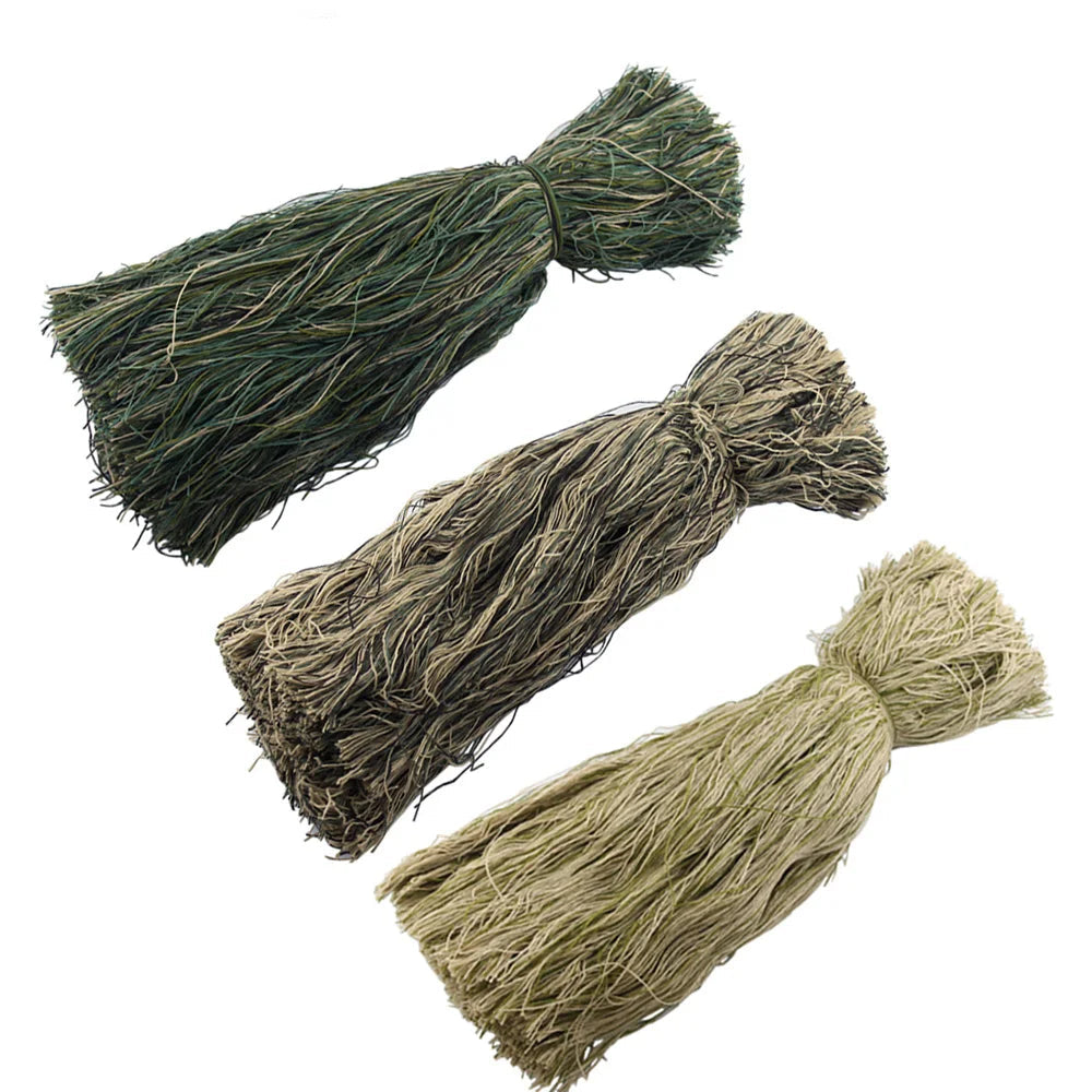 Three bundles of green and brown grass-like material Ghillie Burlap / Yarn / Hessian / Twine / Jute on a white background