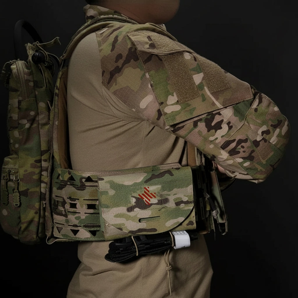 Person wearing a camouflage tactical vest with a backpack showing the first aid pouch on gear on a black background
