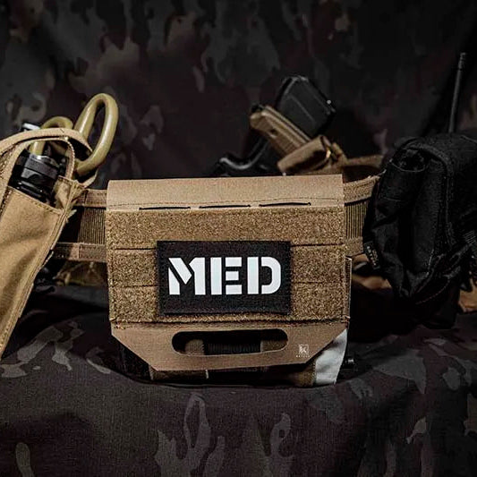 Tactical belt with medical pouch labeled 'MED' on a camouflage background