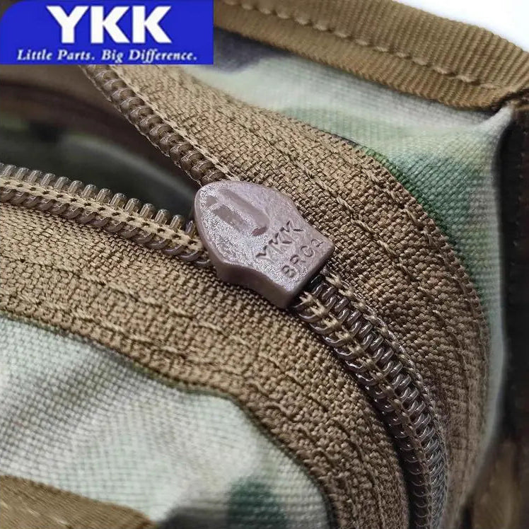 Close-up of a zipper on Multicam camouflage fabric with YKK branding