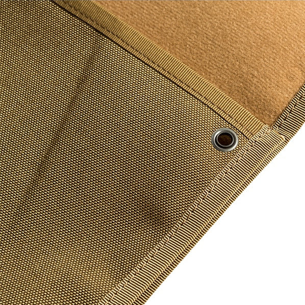 Close-up of a brown hook and loop patch display board with a heavy-duty grommet on a white background