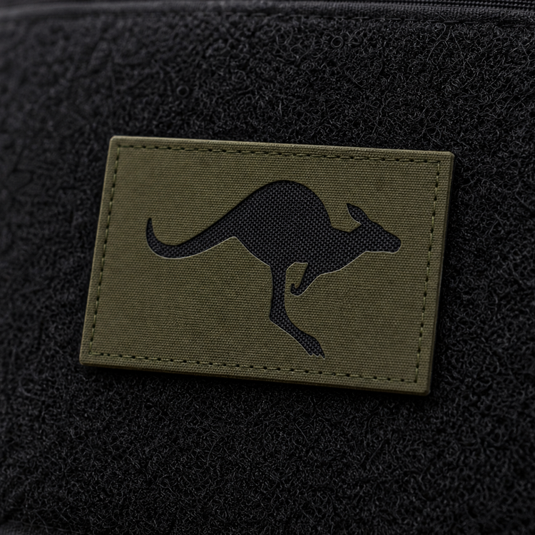 Olive Green Skippy Patch with recessed black nylon backing on a tactical pack